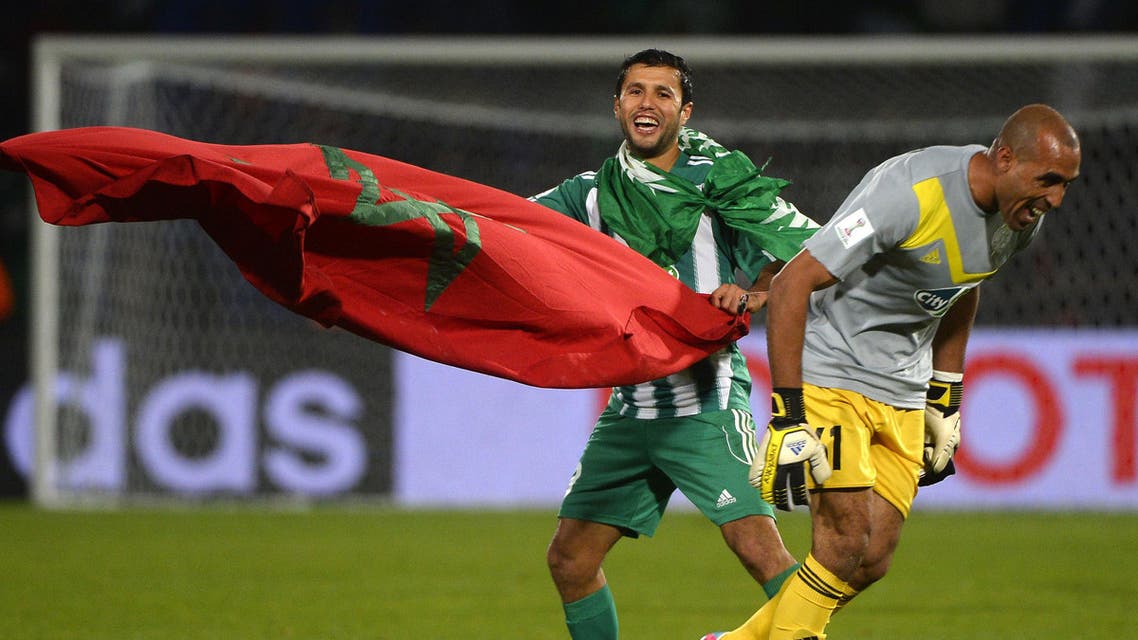 Morocco Raja Casablanca's goalkeeper Khalid Askri (L) celebrates after winning the semi-final football match against Brazil's Atletico Mineiro