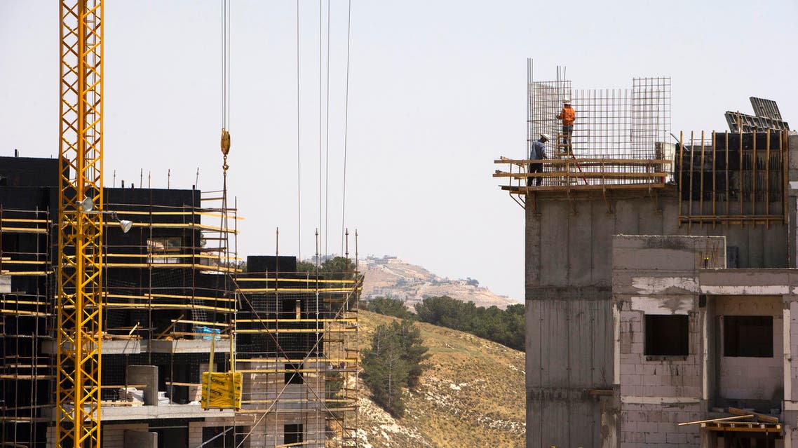 Laborers work on a construction site in a Jewish settlement near Jerusalem known to Israelis as Har Homa and to Palestinians as Jabal Abu Ghneim, pictured in May 2013. (File photo: Reuters)