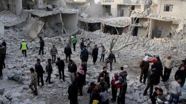 Residents search for survivors at a damaged site after what activists said was an air strike from forces loyal to Syria's President Bashar al-Assad in Tareek Al-Bab area of Aleppo, December 18, 2013.
