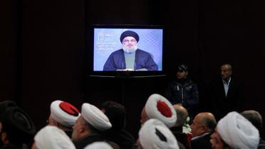 Shi'ite and Sunni Muslim clerics listen to Lebanon's Hezbollah leader Sayyed Hassan Nasrallah addressing his supporters via a screen during a ceremony to mark the death of Hezbollah commander Hasan al-Laqqis in Beirut's southern suburbs December 20, 2013. reuters