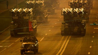 Armoured vehicles are driven past the walls of the Kremlin during a night training exercise for the V-day military parade in Moscow April 29, 2008.