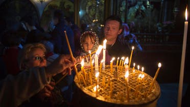 Visitors light candles in the Church of the Nativity, the site revered by Christians as Jesus' birthplace, ahead of Christmas in the West Bank town of Bethlehem. (Reuters) 