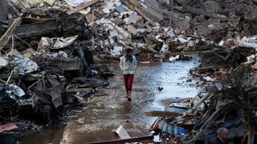 A boy walks past debris at the site of an explosion at the Building of the Directorate of Security in Egypt's Nile Delta town of Dakahlyia, about 120 km (75 miles) northeast of Cairo December 24, 2013. 
