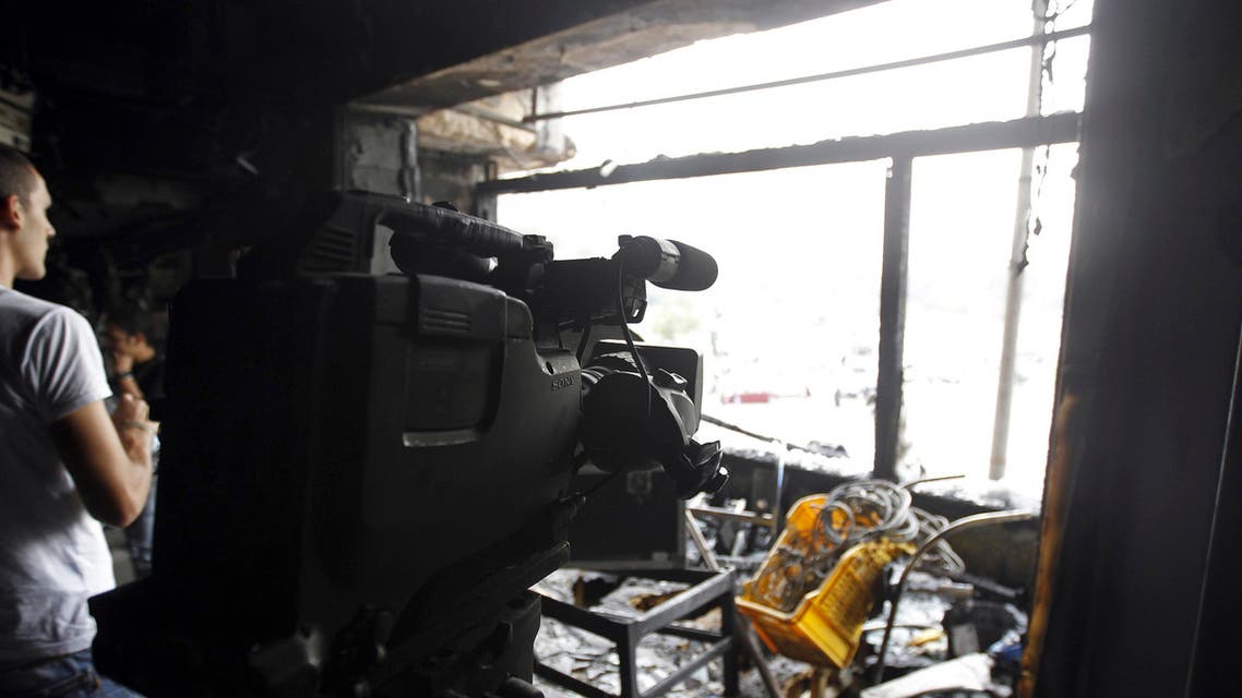 People are seen in a burnt studio of Al Jazeera TV network, at Tahrir Square in Cairo Nov. 21, 2012. (File photo: Reuters)