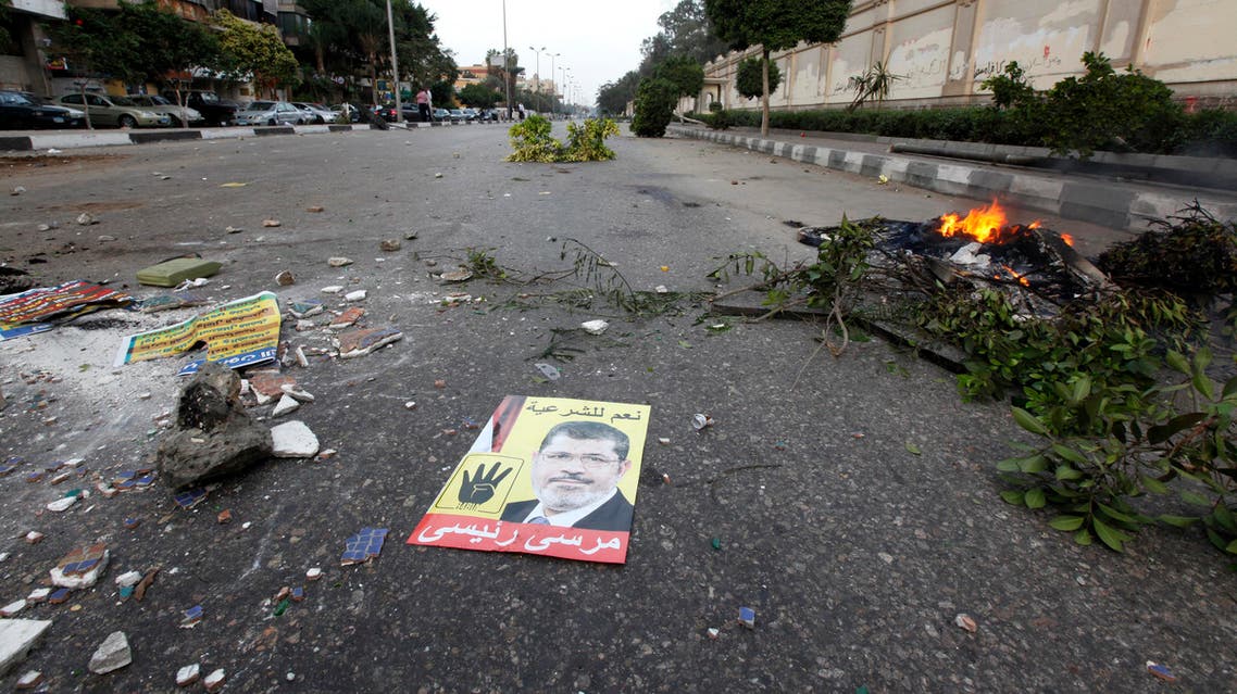 A poster of ousted Egyptian President Mohamed Mursi is seen on ground during clashes between supporters of the Muslim Brotherhood and riot police in Cairo last month. (Reuters)