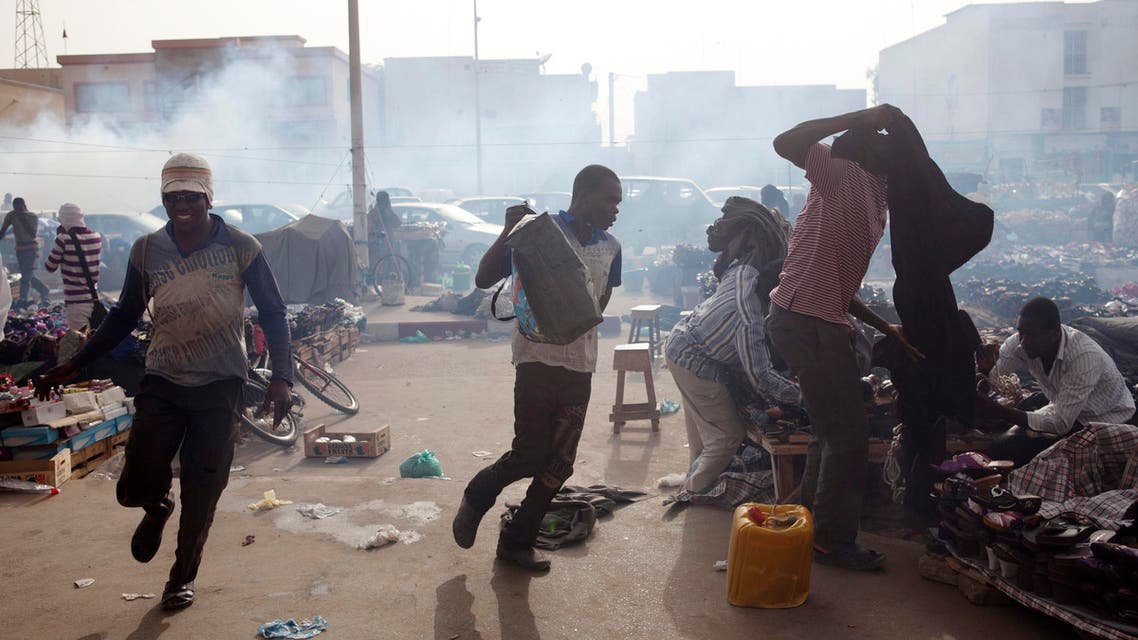 Men run from tear gas fired by police during an anti-slavery demonstration in 2012 in Nouakchott, Mauritania. (Reuters)