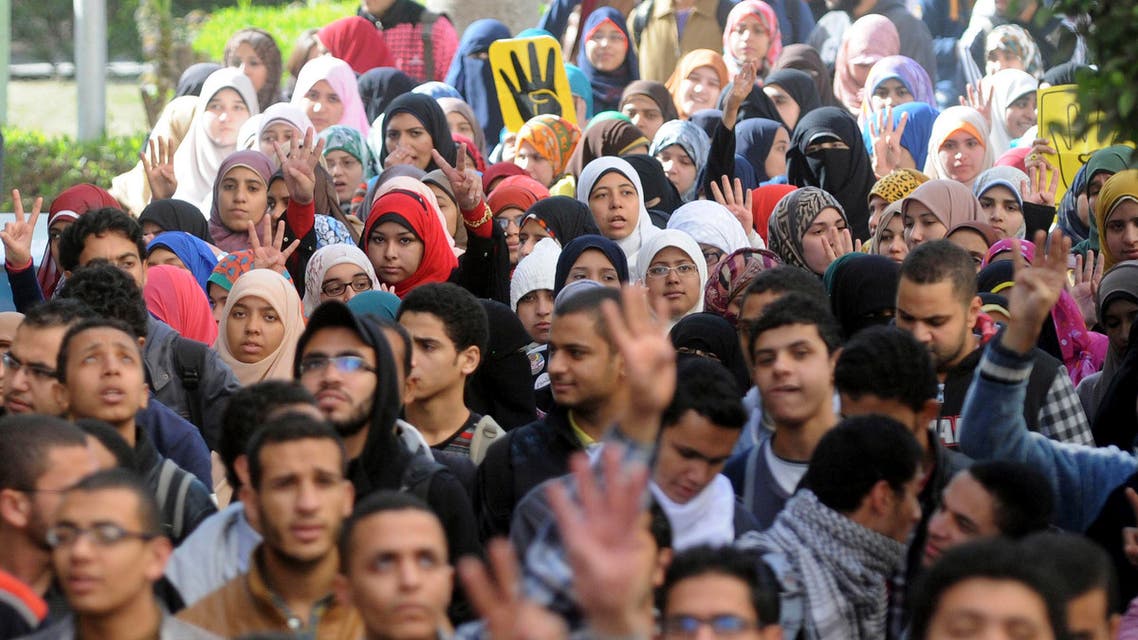 Cairo University students supporting the Muslim Brotherhood and deposed President Mohamed Mursi, gesture the "Rabaa" sign and shout slogans at the university's campus in Cairo December 29, 2013. reuters
