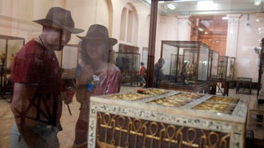 Tourists look at Egyptian artifacts at the Egyptian Museum in cairo. reuters