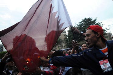 Egyptians burn a Qatari flag during a protest against what they say is Qatar's backing of ousted Egyptian president Mohamed Mursi's government, outside the Qatari Embassy in Cairo November 30, 2013