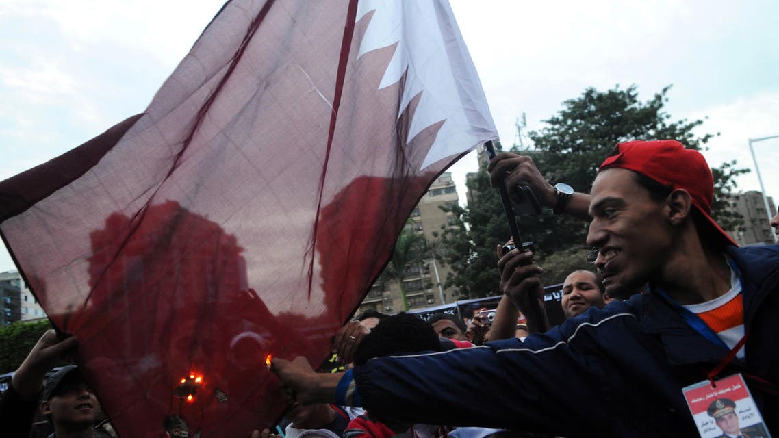 Egyptians burn a Qatari flag during a protest against what they say is Qatar's backing of ousted Egyptian president Mohamed Mursi's government, outside the Qatari Embassy in Cairo November 30, 2013