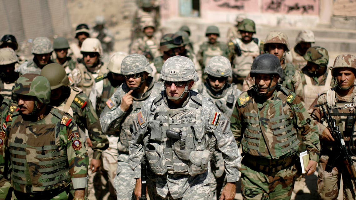 Major-General Mark Hertling (C), the commander of the U.S. forces in northern Iraq, walks during a battlefield circulation patrol on the streets in Mosul June 19, 2008.