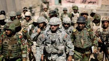 Major-General Mark Hertling (C), the commander of the U.S. forces in northern Iraq, walks during a battlefield circulation patrol on the streets in Mosul June 19, 2008. 