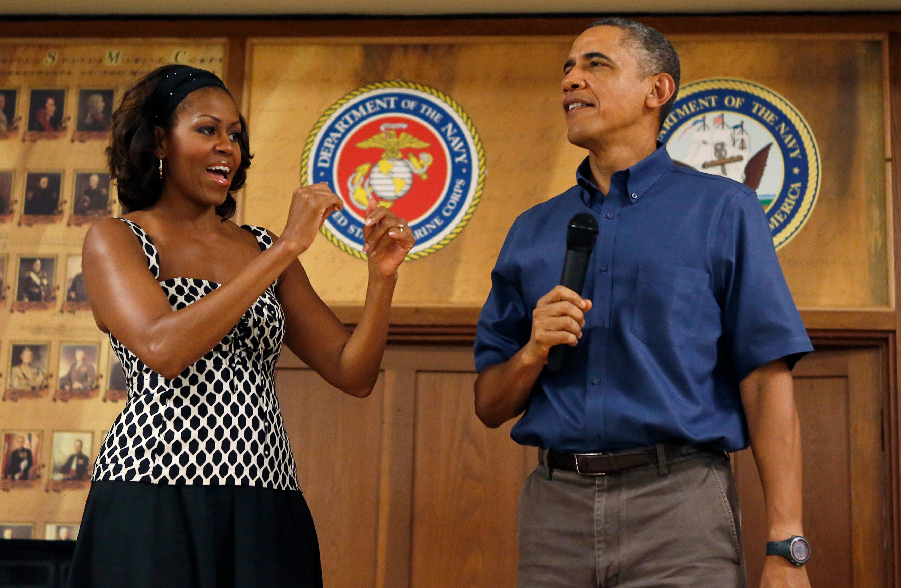 U.S. President Barack Obama and first lady Michelle Obama address military personnel during a Christmas day visit to Marine Corps Base Hawaii in Kaneohe, Hawaii December 25, 2013. reuters
