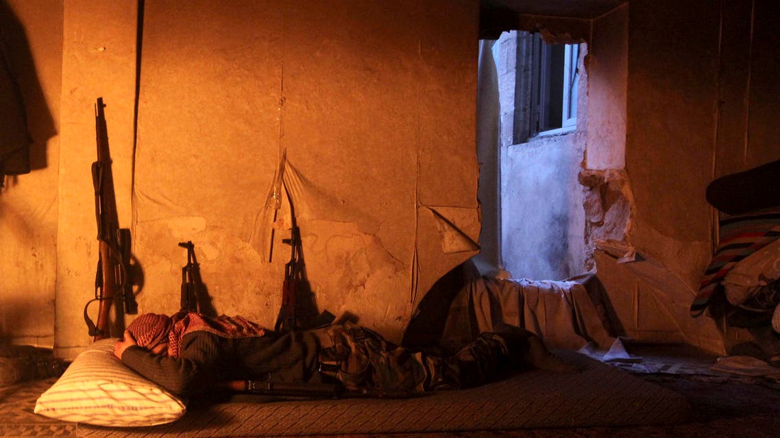 A Free Syrian Army fighter rests in a safehouse on a frontline in Old Aleppo January 5, 2014.