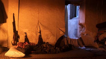 A Free Syrian Army fighter rests in a safehouse on a frontline in Old Aleppo January 5, 2014. 