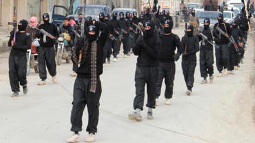 Fighters of al-Qaeda linked Islamic State of Iraq and the Levant carry their weapons during a parade at the Syrian town of Tel Abyad, near the border with Turkey Jan. 2, 2014. (Reuters)