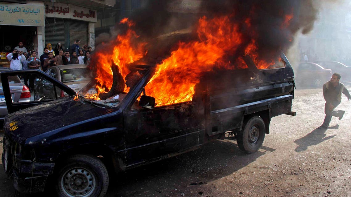 Protesters who support ousted President Mohammad Mursi, set a police vehicle on fire during clashes with riot police at Nasr City district in Cairo Jan. 10, 2014. (Reuters)