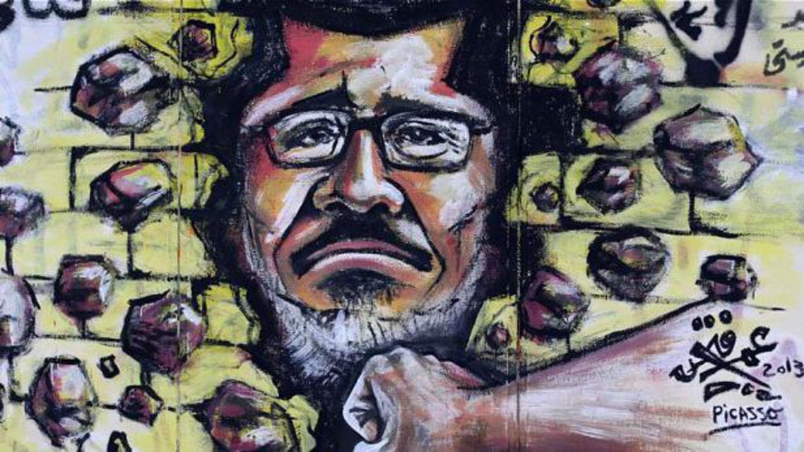 Graffiti depicting Egypt's Islamist President Mohammed Morsi covers an outer wall of the presidential palace in Cairo AP