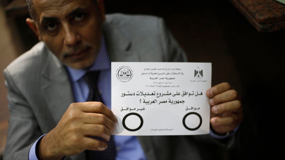 An Egyptian man displays the voting paper of a referendum on the new constitution at the Egypt Consulate in Dubai January 8, 2014.