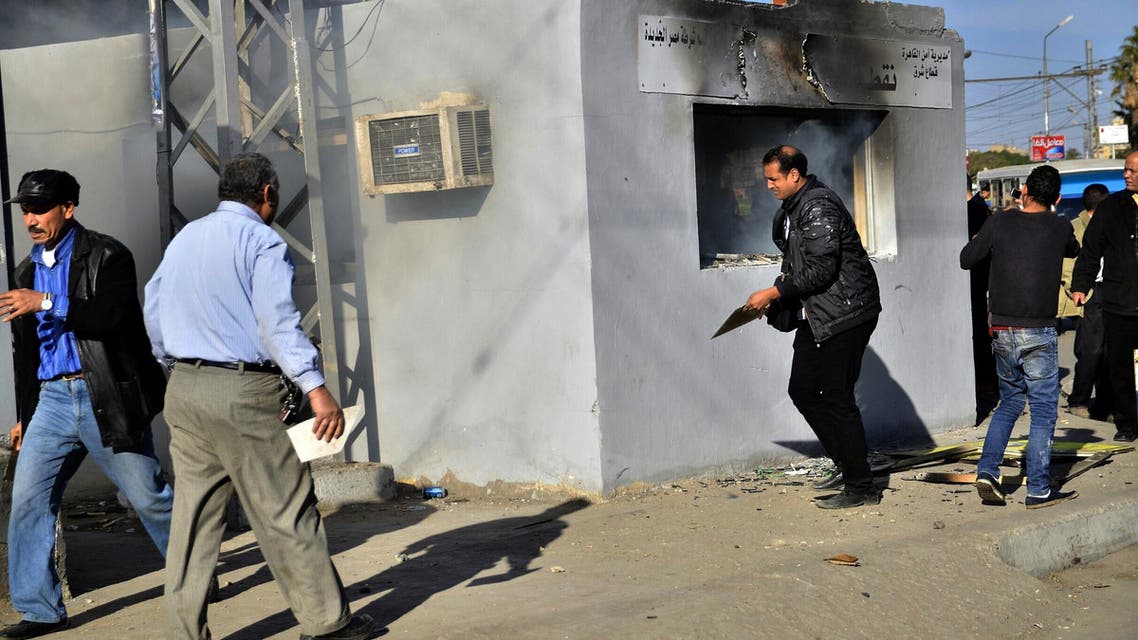Egyptians gather outside a police station after it was set on fire by Muslim Brotherhood supporters of ousted president Mohammad Mursi during their march to Roxsy Square in the Heliopolis district of Cairo on Jan. 15, 2014. (Reuters)
