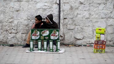 Children sell washing detergent in Aleppo on Dec. 1, 2013. The escalation of the civil war in Syria has taken its toll on the region’s economy, the World Bank said. (File photo: Reuters)