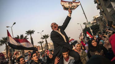 An Egyptian man holds a portrait of Egypt's Defence Minister General Abdel Fattah al-Sisi outside a polling station during the vote on a new constitution on January 14, 2014 in Giza, Cairo AFP