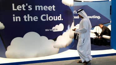 A visitor uses his mobile phone as he walks at the Gulf Information and Technology Exhibition (GITEX) in Dubai October 17, 2010. (Reuters)