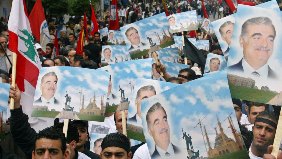 Lebanese mourners carry the portrait of former Lebanese prime minister Rafik al-Harir during his funeral procession in Beirut on Feb. 16, 2005. (Reuters)