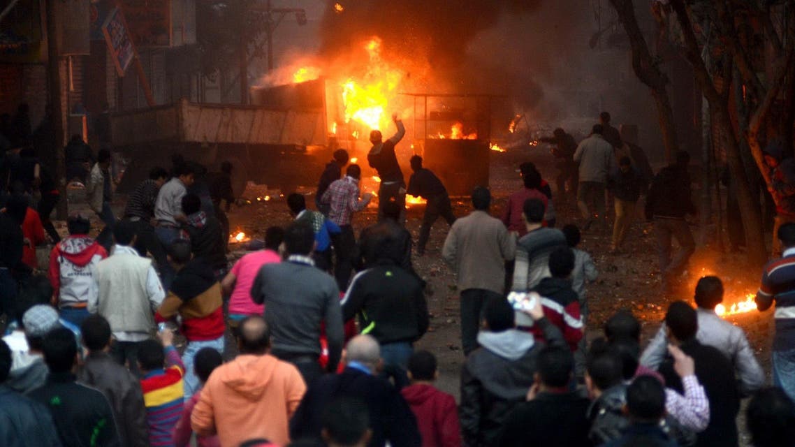 Supporters of the Muslim Brotherhood clash with civilians and Egyptian riot police in Alf Masskan district in the capital Cairo on Jan. 17, 2014. (Reuters)