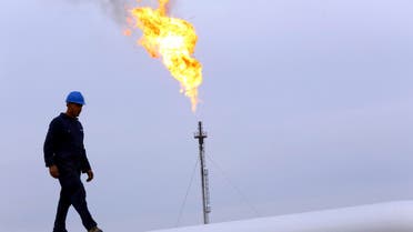 A worker walks on an oil pipeline at Khurmala oilfield on the outskirts of the city of Erbil, in Iraq's Kurdistan region. (File photo Reuters)