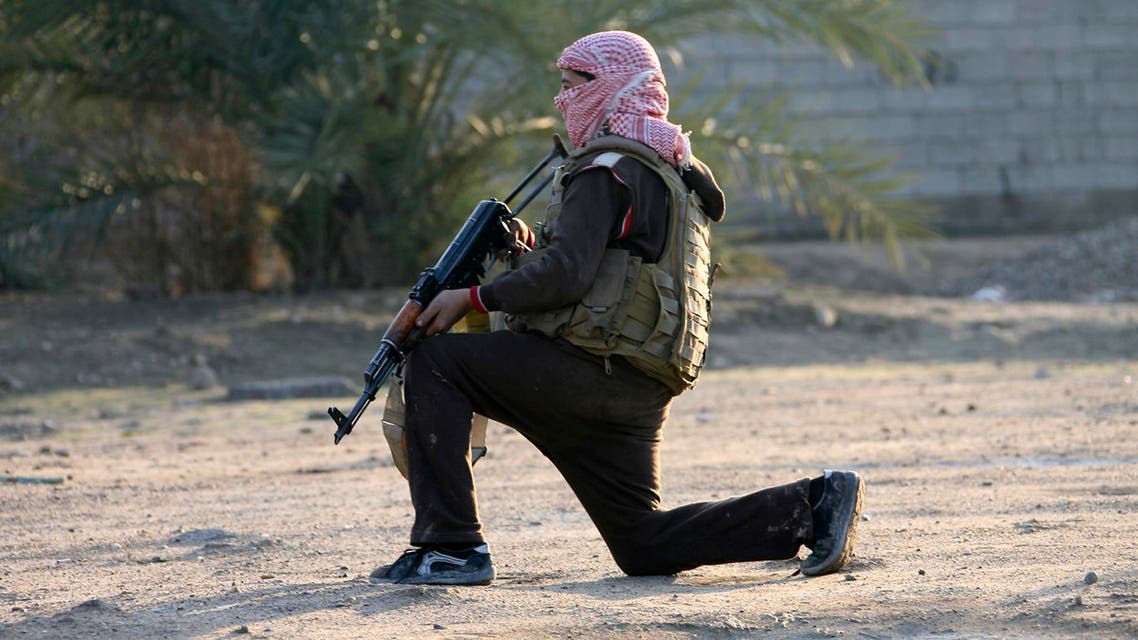 A masked Sunni Muslim gunman takes position with his weapon during a patrol in the city of Falluja, 70 km (44 miles) west of Baghdad January 15, 2014. reuters