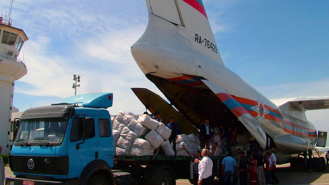 Workers are seen unloading humanitarian aid sent from Russia to the Syrian government in this handout photograph distributed by Syria's national news agency SANA on May 28,2013. Reuters