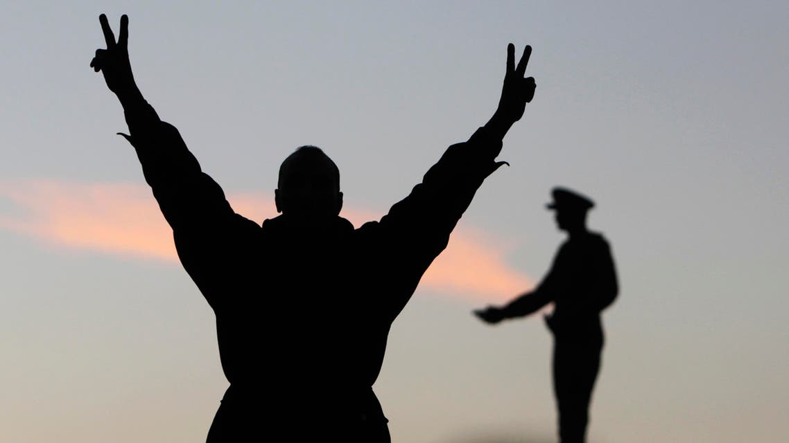 A supporter of the constitution gestures in front of a statue of Egypt's former Army Chief of Staff Abdel Moneim Riad near Tahrir square reuters