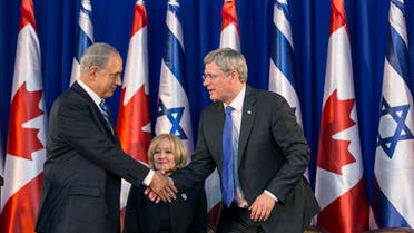 Israel's Prime Minister Benjamin Netanyahu (L) shakes hands with his Canadian counterpart Stephen Harper as Harper's wife Laureen watches during a welcoming ceremony for Harper at Netanyahu's office in Jerusalem January 19, 2014. 
