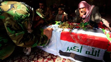 Mourners grieve near the coffin of a fighter from the Iraqi Shi'ite the Badr Organization, who was killed in clashes with the Free Syrian Army, during a funeral in Najaf, 160 km (99 miles) south of Baghdad, January 16, 2014. 