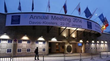 A person walks past the entrance of the congress centre for the annual meeting of the World Economic Forum (WEF) 2014 in the early morning in Davos January 21, 2014. 