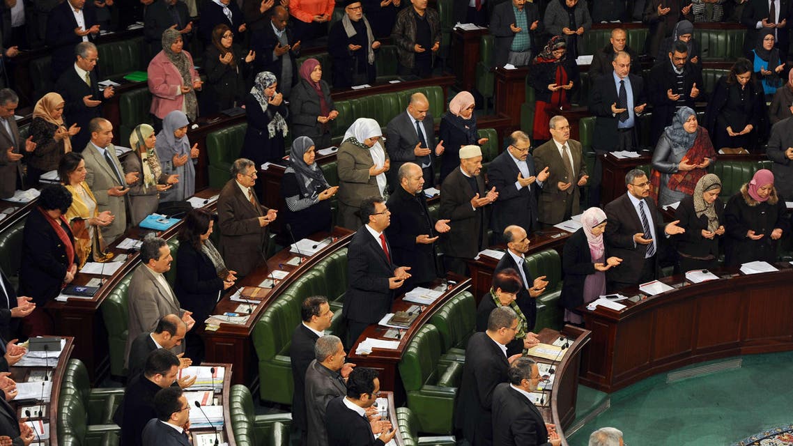 Tunisian MPs recite the Fatiha, the opening Surat (brief chapter) of the Koran, during a meeting at the National Constituent Assembly (NCA) as part of the debates on a new constitution on Jan. 23, 2014, in Tunis. (AFP)