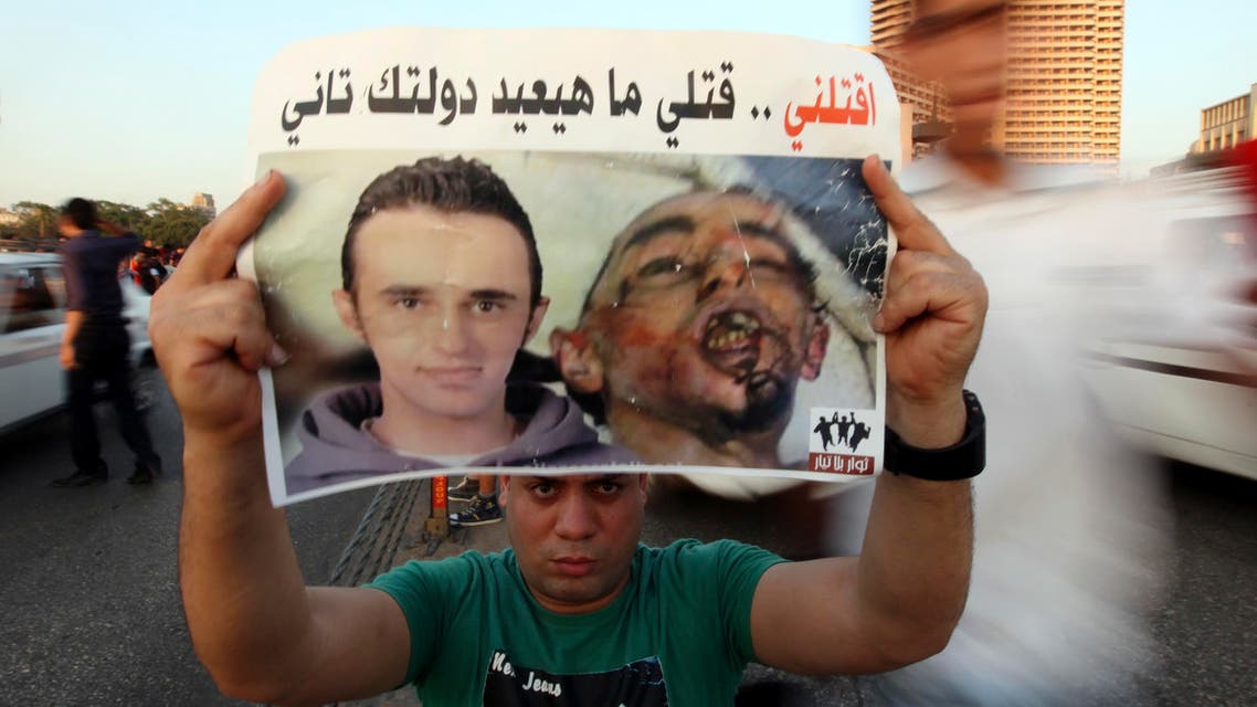 A demonstrator carries a poster of Egyptian Khaled Said on the second anniversary of his death over Qasr El Nile bridge in Cairo