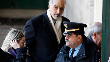 Luna Chebel (L) and Bashar al Jaafari (C), part of a Syrian government delegation, arrive for a meeting with U.N.-Arab League envoy for Syria Lakhdar Brahimi (not seen) at a U.N. office in Geneva January 24, 2014. 