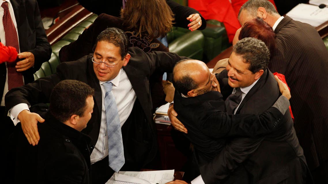 Members of the Tunisian parliament celebrate after approving the country's new constitution in the assembly building in Tunis January 26, 2014. (Reuters)