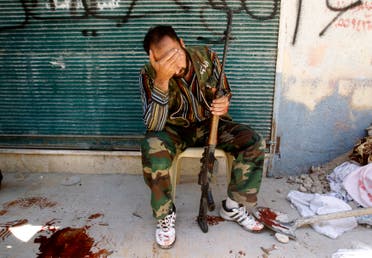 A Free Syrian Army fighter reacts after his friend was shot by Syrian Army soldiers during clashes in the Salah al-Din neighbourhood in central Aleppo in this August 4, 2012 file photo. reuters