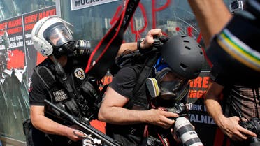 A Turkish riot policeman pushes a photographer during a protest at Taksim Square in Istanbul June 11, 2013. (File photo: Reuters)