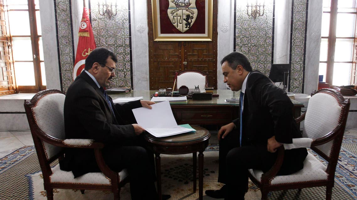 Tunisia's Prime Minister Mehdi Jomaa (R) meets with former Prime Minister Ali Larayedh during a handover ceremony at the government palace in Tunis January 29, 2014. reu