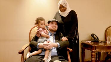 Saudi pilot Nawal al-Husawi, her husband David McCarthy and their child pose for a picture after an interview in Riyadh. (Al Arabiya)