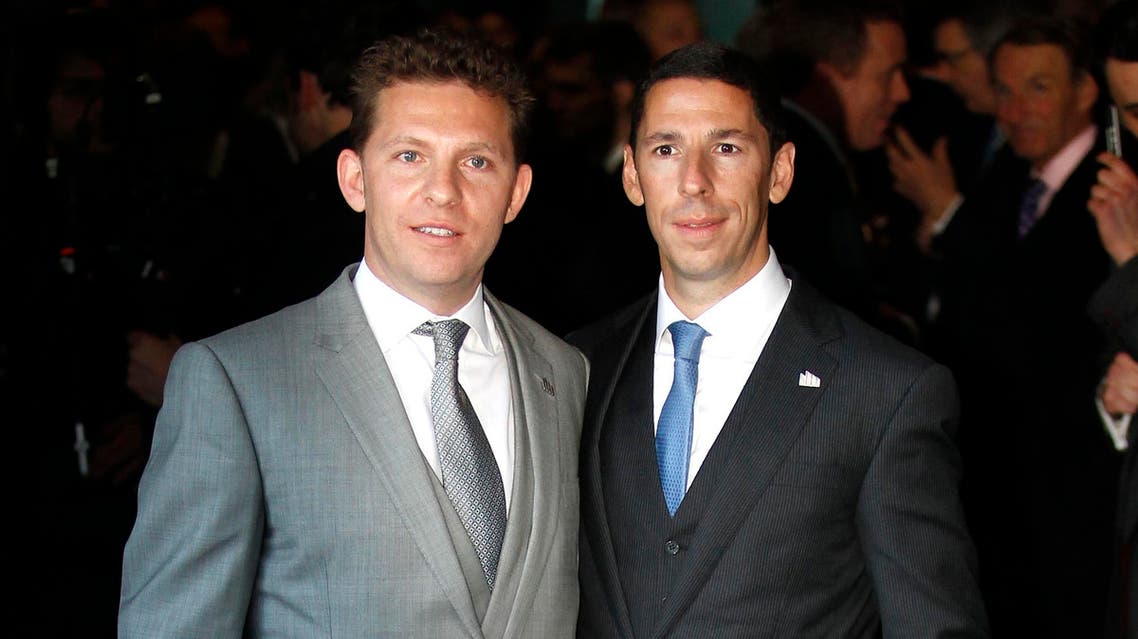 Nick and Chris Candy pose for photographers at the launch of the One Hyde Park development in London on Jan. 19, 2011. (File photo: Reuters)