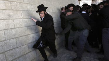 Israeli policemen scuffle with ultra-Orthodox Jews during a protest against their young men being called up for military service on Feb. 6, 2014 in Jerusalem. (AFP)
