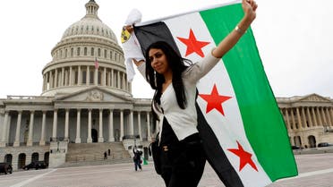 An anti-Assad protester carries the Syrian freedom flag in front of the U.S. Capitol in Washington Reuters