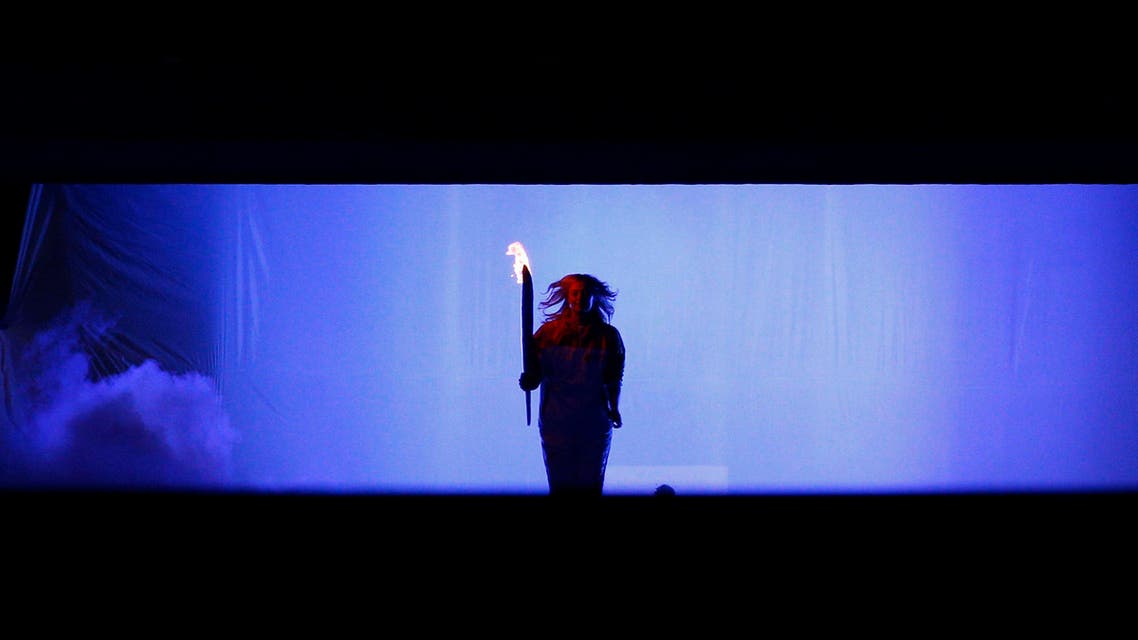 Russian tennis player Maria Sharapova holds the Olympic Torch during the opening ceremony of the 2014 Sochi Winter
