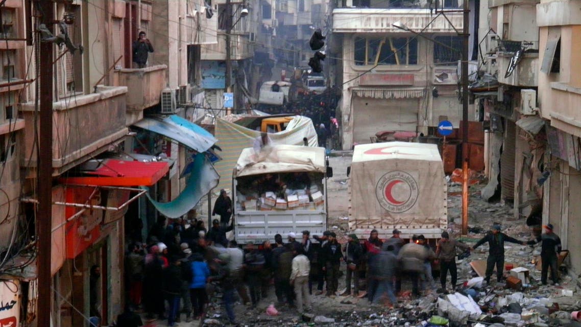 Syrian Arab Red Crescent trucks stand in the besieged neighbourhoods of Homs to supply humanitarian aid February 8, 2014. reuters