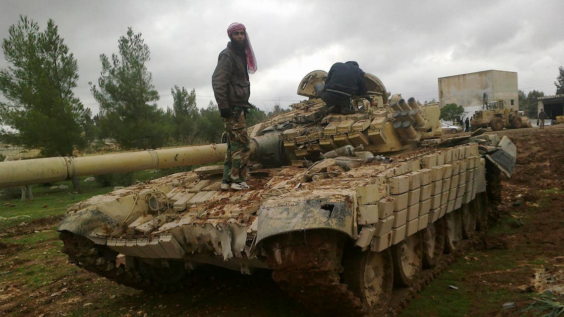 Free Syrian Army fighters inspect a tank after the fighters said they fought and defeated government troops in Al-Latameneh, near Hama December 22, 2012.